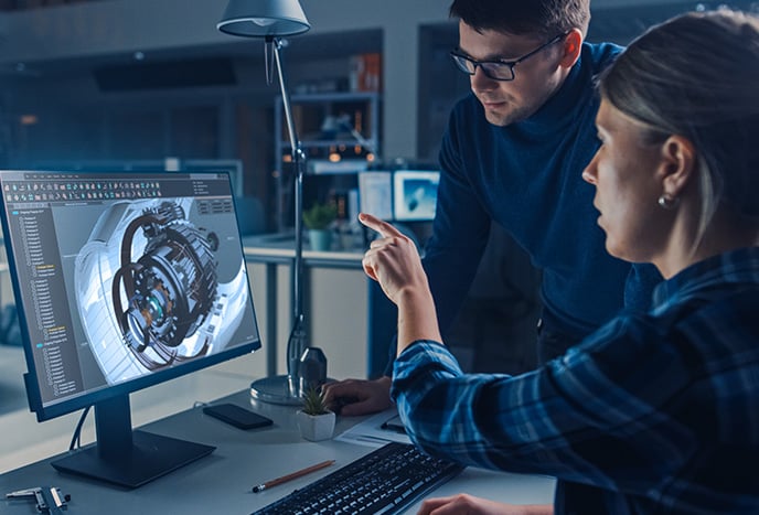 a female and male manufacturing professional assessing equipment on a computer